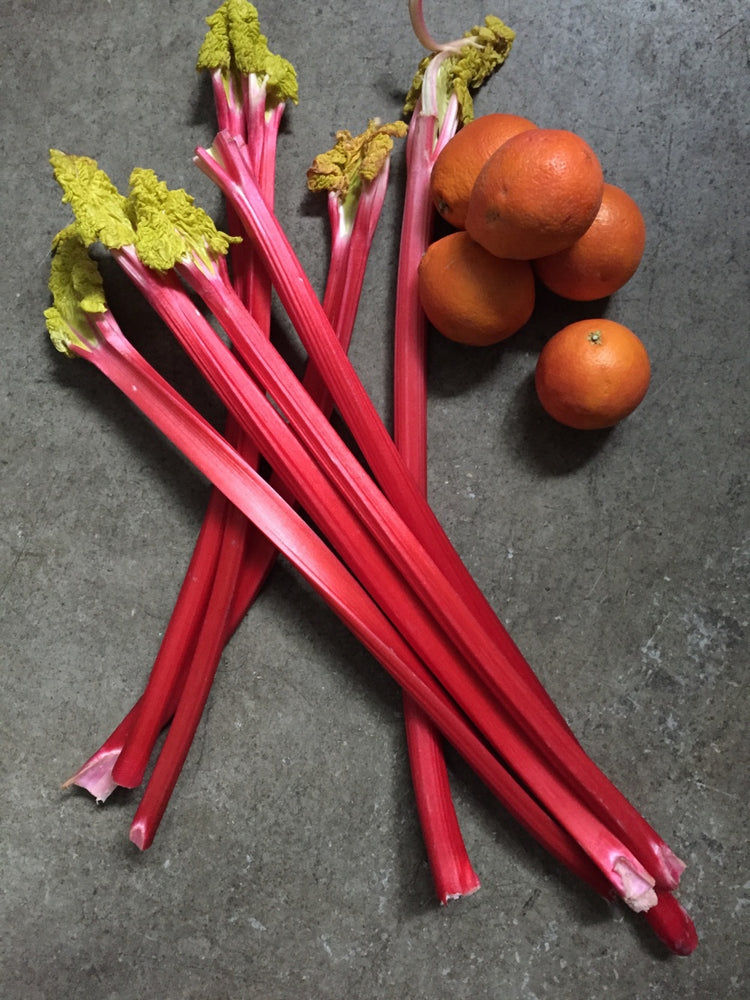 Cut rhubarb place over the top of each other with oranges to the side